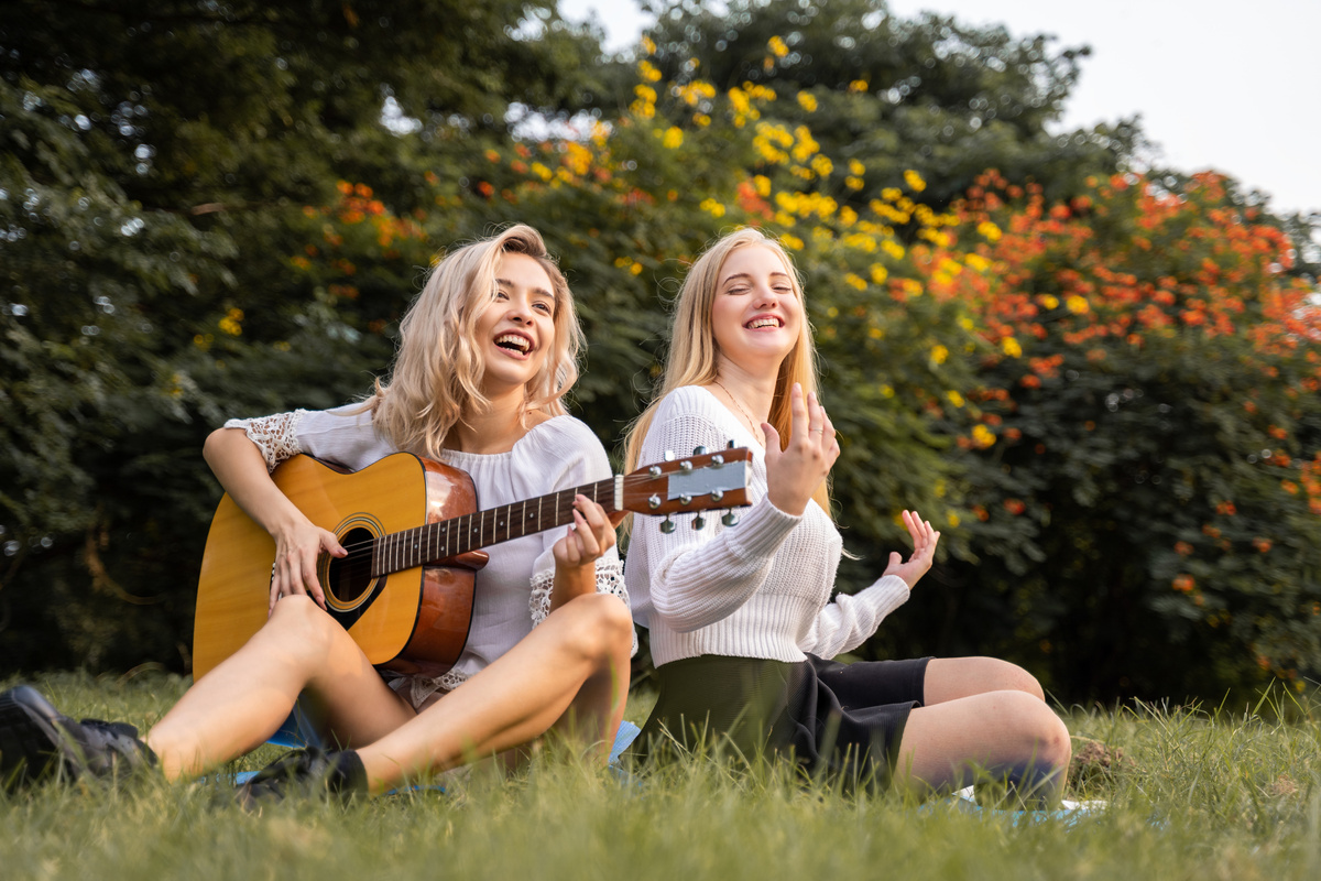 Young Women Playing the Guitar at Park